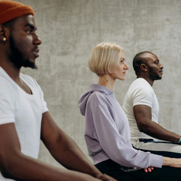 Diverse group of people sitting in a calm yoga class.